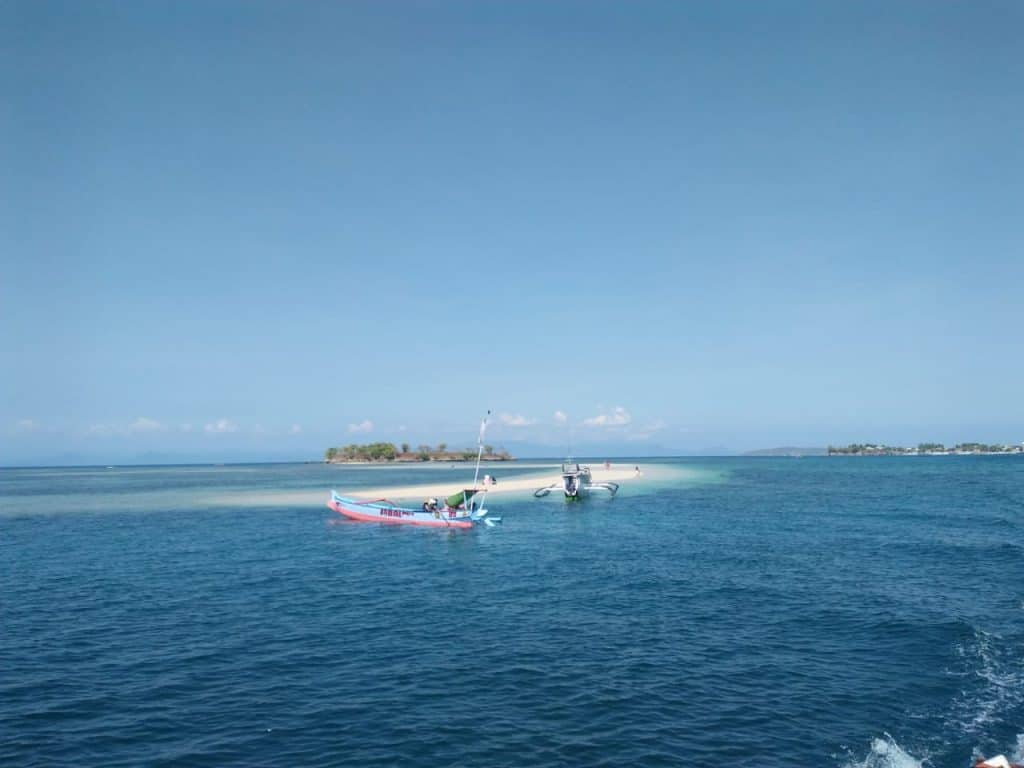 Boat cruising across turquoise sea